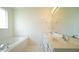 Bathroom with double sinks, soaking tub, and large mirror at 4024 Claret Ln, Morrisville, NC 27560