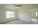 Neutral bedroom with large window, carpet, and doorway to another bedroom at 4024 Claret Ln, Morrisville, NC 27560