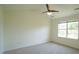 Bedroom features a ceiling fan and a large window for natural light at 4024 Claret Ln, Morrisville, NC 27560