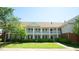 Two-story building with white siding, green grass, bushes, and black shutters at 4024 Claret Ln, Morrisville, NC 27560