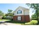 Two-story building with white siding, brick facade, green grass, and black shuttered windows at 4024 Claret Ln, Morrisville, NC 27560