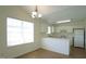 Kitchen and dining area with white cabinets, appliances, countertops, and linoleum floors at 4024 Claret Ln, Morrisville, NC 27560