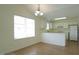 Kitchen and dining area with white cabinets, appliances, countertops, and linoleum floors at 4024 Claret Ln, Morrisville, NC 27560