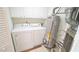 Functional laundry area with washer, dryer, water heater, and storage cabinets at 4024 Claret Ln, Morrisville, NC 27560