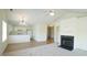 Open-concept kitchen and living area with fireplace, ceiling fan, and neutral color palette at 4024 Claret Ln, Morrisville, NC 27560