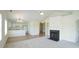 Living area showcasing the fireplace, ceiling fan, open floorplan, and a doorway to other rooms at 4024 Claret Ln, Morrisville, NC 27560