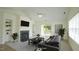 Bright living room with fireplace, neutral carpet, slider to balcony, and gray sofa at 4024 Claret Ln, Morrisville, NC 27560