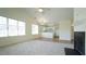 Open floor plan living room with carpet, eat-in kitchen with white cabinets, and fireplace at 4024 Claret Ln, Morrisville, NC 27560