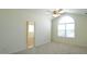 Bright bedroom with vaulted ceiling, large arched window, and ensuite bathroom entrance at 4024 Claret Ln, Morrisville, NC 27560