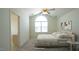 Bright bedroom with vaulted ceiling, large arched window, and ensuite bathroom entrance at 4024 Claret Ln, Morrisville, NC 27560
