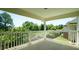 Spacious outdoor patio area with white railings and views of the surrounding trees and landscape at 4024 Claret Ln, Morrisville, NC 27560