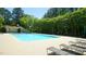 Relaxing community pool with lounge chairs, clear blue water, and a bath house surrounded by mature trees at 4024 Claret Ln, Morrisville, NC 27560