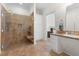 Tiled bathroom features a walk-in shower, a sink, and white storage cabinets at 416 Mitchell St, Hillsborough, NC 27278
