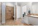Bathroom featuring a tiled shower with a glass door and accessibility features at 416 Mitchell St, Hillsborough, NC 27278