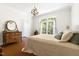 Well-lit bedroom featuring a window and a dresser with a decorative mirror at 416 Mitchell St, Hillsborough, NC 27278
