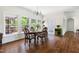 Bright dining room featuring hardwood floors, a chandelier, and windows overlooking a deck at 416 Mitchell St, Hillsborough, NC 27278