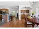 Dining room with hardwood floors open to the kitchen and bar with tiled wall at 416 Mitchell St, Hillsborough, NC 27278