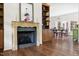 Elegant fireplace and built-in bookcase adjacent to the dining room with hardwood floors at 416 Mitchell St, Hillsborough, NC 27278