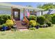 Inviting front porch adorned with lush greenery and a charming wooden door and American flag at 416 Mitchell St, Hillsborough, NC 27278