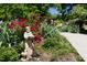 Charming garden with vibrant roses, lush greenery, and a statue at 416 Mitchell St, Hillsborough, NC 27278