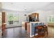Open kitchen with stainless steel appliances, a tiled breakfast bar, and a view to the yard at 416 Mitchell St, Hillsborough, NC 27278