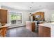 Open concept kitchen featuring stainless steel appliances, light countertops, and a large window at 416 Mitchell St, Hillsborough, NC 27278