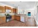 Kitchen featuring stainless appliances, wooden cabinetry, and an open floor plan at 416 Mitchell St, Hillsborough, NC 27278