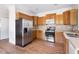 Bright kitchen featuring updated appliances, wooden cabinets, and ample counter space at 416 Mitchell St, Hillsborough, NC 27278