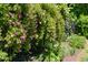 Charming pink roses adorn a black iron fence, enhancing the garden's appeal at 416 Mitchell St, Hillsborough, NC 27278
