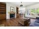 Bright living room showcasing hardwood floors, a fireplace, and seamless flow into the dining area at 416 Mitchell St, Hillsborough, NC 27278