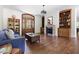 Open-concept living room featuring hardwood floors, a fireplace, built in cabinets and natural light at 416 Mitchell St, Hillsborough, NC 27278
