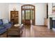 Spacious living room featuring hardwood floors, a charming wooden door, and cozy seating at 416 Mitchell St, Hillsborough, NC 27278