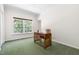 Bright office space with a large window and a wooden desk on green carpet at 416 Mitchell St, Hillsborough, NC 27278