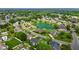 Aerial view of a neighborhood featuring mature trees surrounding a picturesque lake and various home styles at 4589 Freedom Dr, Burlington, NC 27215