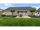 A well-maintained backyard featuring a patio with an outdoor dining set and lush green lawn at 4589 Freedom Dr, Burlington, NC 27215
