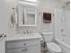 Well-lit bathroom with a shower-tub combo, white vanity, square mirror, and modern fixtures at 4589 Freedom Dr, Burlington, NC 27215