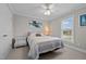 Cozy bedroom with a ceiling fan, window, neutral carpet, and patterned bedding at 4589 Freedom Dr, Burlington, NC 27215
