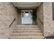 Close up of the brick staircase leading up to the front door with glass accents and a potted plant at 4589 Freedom Dr, Burlington, NC 27215