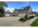 Spacious brick home with a three car garage, and large driveway and lush landscaping at 4589 Freedom Dr, Burlington, NC 27215