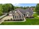 Beautiful single-story brick home with a manicured lawn, mature landscaping, and a detached garage at 4589 Freedom Dr, Burlington, NC 27215