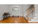 Bright foyer featuring hardwood floors, a staircase, and a white front door with decorative glass panels at 4589 Freedom Dr, Burlington, NC 27215
