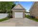 Detached garage with a brick exterior, white trim, and well maintained lawn at 4589 Freedom Dr, Burlington, NC 27215