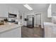 Modern kitchen with white cabinets, stainless steel appliances, and dark wood flooring at 4589 Freedom Dr, Burlington, NC 27215