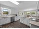 Bright kitchen boasts white cabinets, stainless appliances, granite countertops, and adjacent dining area at 4589 Freedom Dr, Burlington, NC 27215