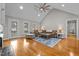 Spacious living room featuring a vaulted ceiling, fireplace, and wood flooring with natural lighting at 4589 Freedom Dr, Burlington, NC 27215