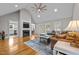 Bright living room with high ceilings, fireplace, wood floors, and ample seating at 4589 Freedom Dr, Burlington, NC 27215