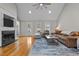 Light-filled living room boasts a cozy fireplace, wood floors, and comfortable furnishings at 4589 Freedom Dr, Burlington, NC 27215
