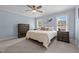 Serene main bedroom with two windows, soft blue walls, neutral carpet, and matching furniture at 4589 Freedom Dr, Burlington, NC 27215