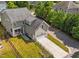 Aerial view of a house with a long driveway, garage and manicured lawn at 508 Vervain Way, Holly Springs, NC 27540