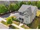 Beautiful aerial view of a home with green siding, gray roof and lovely landscaping at 508 Vervain Way, Holly Springs, NC 27540